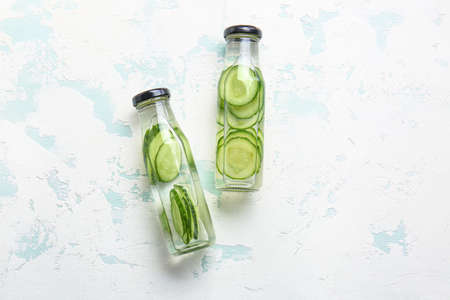 Bottles of cucumber infused water on tableの写真素材