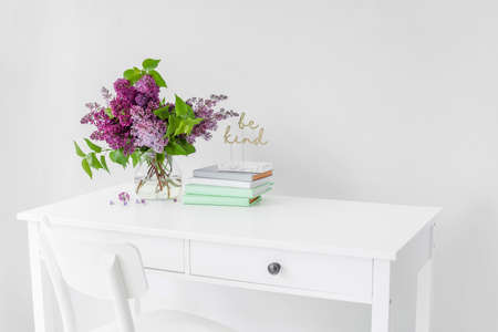 Vase with beautiful lilac flowers on table in roomの写真素材