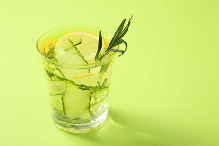 Glass of cucumber infused water on color backgroundの写真素材