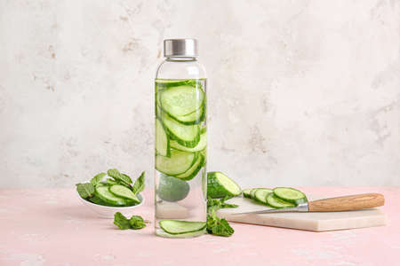 Bottle of cucumber infused water on tableの写真素材