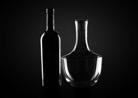 Bottle of wine and decanter on dark backgroundの写真素材
