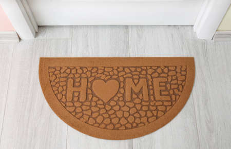 Door mat on wooden floor in hallwayの写真素材