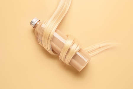 Bottle of shampoo for blonde hair on color backgroundの写真素材