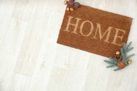 Door mat and Christmas decor on floorの写真素材