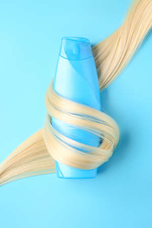 Bottle of shampoo for blonde hair on color backgroundの写真素材