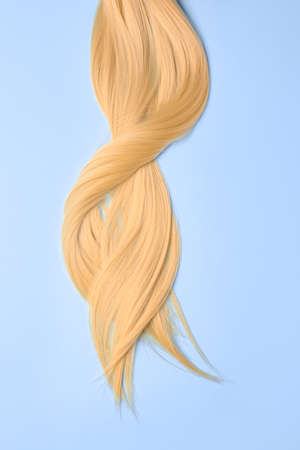 Beautiful long blonde hair on color backgroundの写真素材