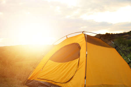 Camping tent in countryside on sunny dayの写真素材