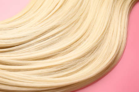 Beautiful long blonde hair on color backgroundの写真素材
