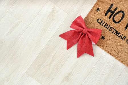 Door mat and Christmas decor on floorの写真素材