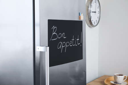 Chalkboard on door of refrigerator in kitchenの写真素材