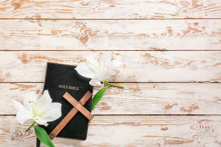 Composition with Holy Bible, cross and flowers on wooden backgroundの写真素材