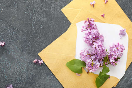 Beautiful lilac flowers and letters on gray backgroundの写真素材