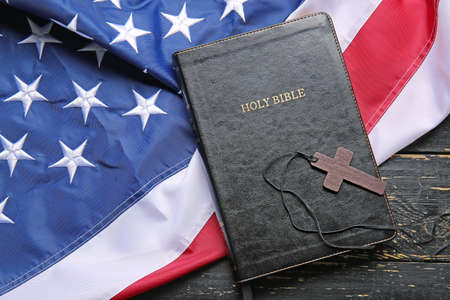 Holy Bible, cross and USA flag on wooden backgroundの写真素材