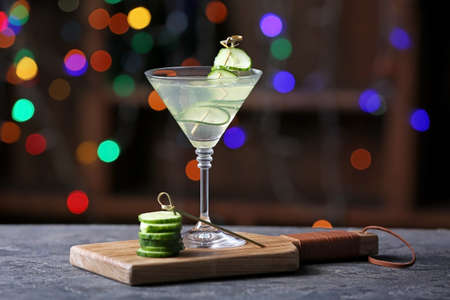 Glass of tasty cucumber martini on table in barの写真素材
