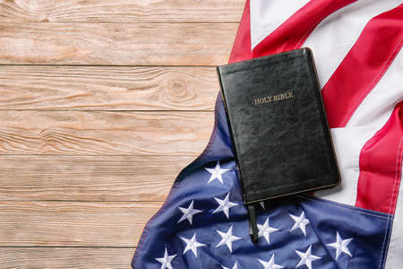 Holy Bible and USA flag on wooden backgroundの写真素材