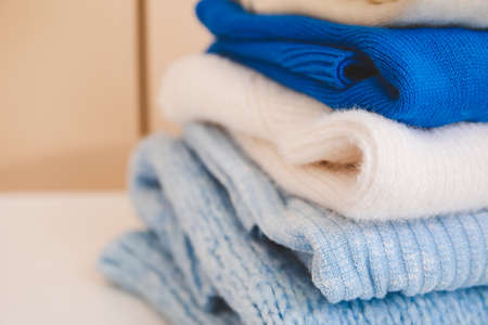 Stack of clean clothes on table, closeupの写真素材