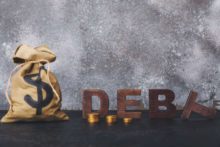 Word DEBT and money on tableの写真素材