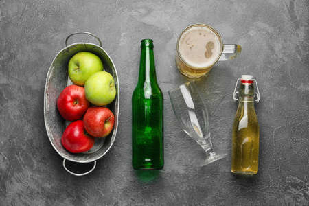 Composition with fresh apple cider on gray background