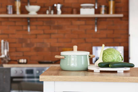 Fresh vegetables with pot on kitchen tableの写真素材