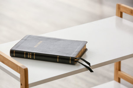 Holy Bible on table in roomの写真素材