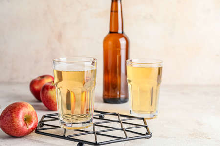 Bottle and glasses of apple cider on tableの写真素材