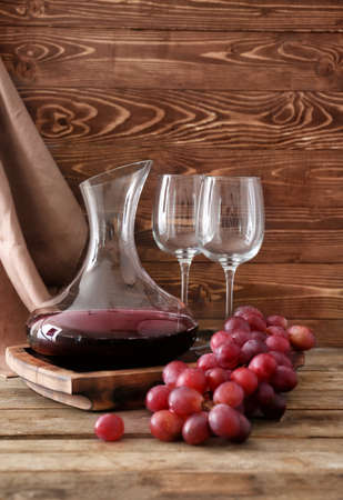 Decanter of wine with glasses on tableの写真素材
