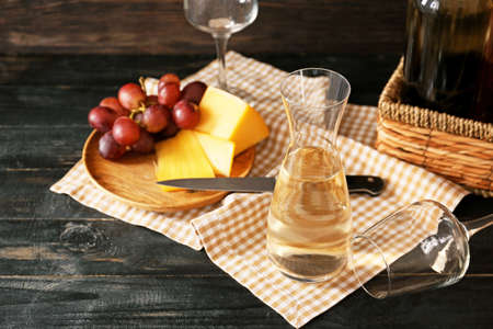 Decanter of wine with cheese on tableの写真素材