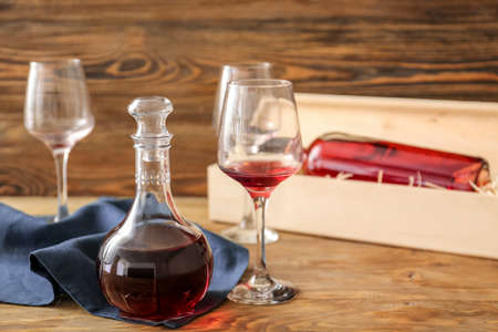 Decanter of wine with glasses on wooden backgroundの写真素材