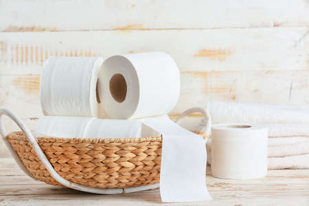 Basket with toilet paper on wooden backgroundの写真素材