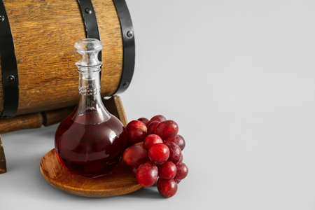 Decanter of wine with barrel on gray backgroundの写真素材