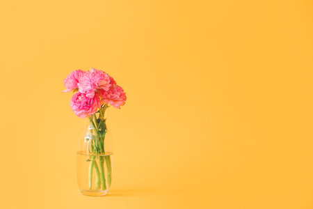 Vase with bouquet of flowers on color backgroundの写真素材