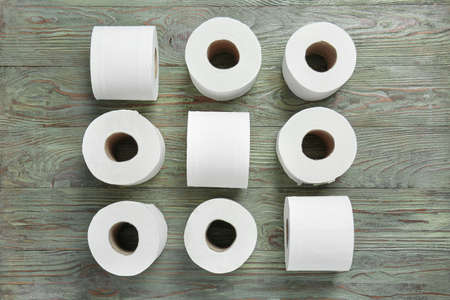 Rolls of toilet paper on wooden background