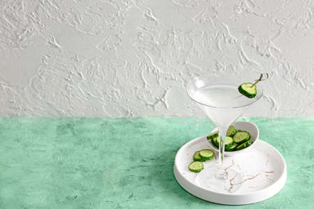 Glass of tasty cucumber martini on tableの写真素材