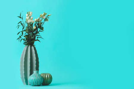Vases with bouquet of flowers on color backgroundの写真素材