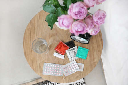 Different means of contraception and clock on tableの写真素材