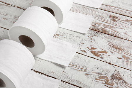 Rolls of toilet paper on wooden backgroundの写真素材