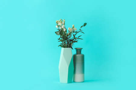 Vases with bouquet of flowers on color backgroundの写真素材