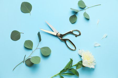 Scissors with floral decor on color backgroundの写真素材