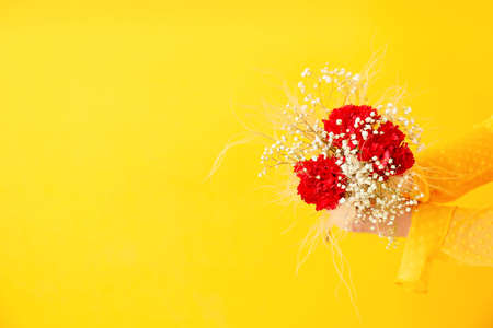 Female hands with beautiful bouquet on color backgroundの写真素材