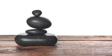 Zen stones on table against white backgroundの写真素材
