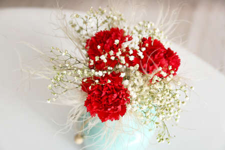 Vase with bouquet of beautiful flowers on table in room, closeupの写真素材