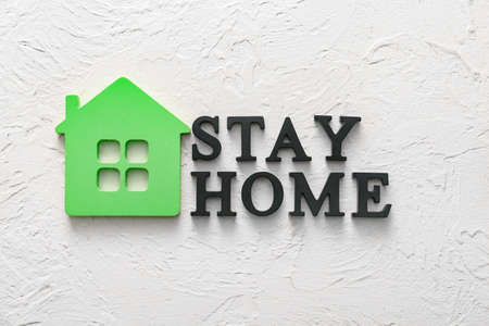 Model of house with text STAY HOME on white backgroundの写真素材