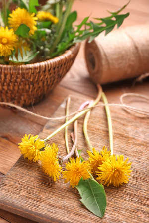 Beautiful dandelions on wooden backgroundの写真素材