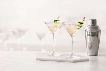 Glasses of tasty cucumber martini on tableの写真素材