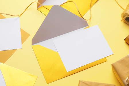 Blank card and envelope on color background