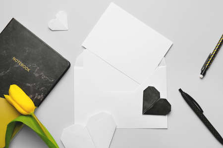 Composition with blank card and envelope on light background