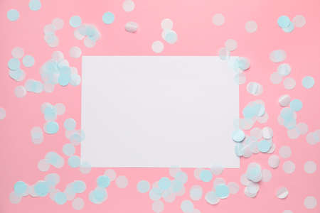 Blank card and confetti on color background