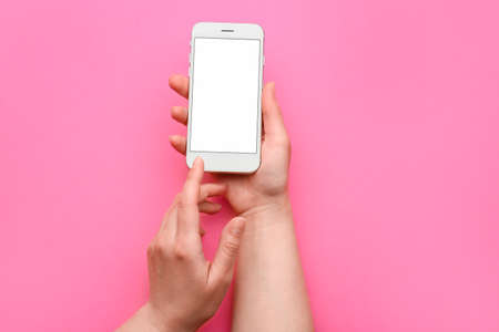 Female hands with mobile phone on color background