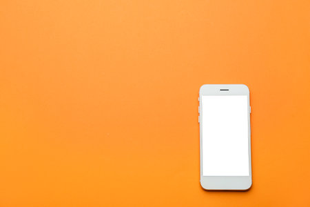 Modern mobile phone on color backgroundの写真素材