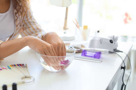 Woman getting professional manicure in beauty salonの写真素材